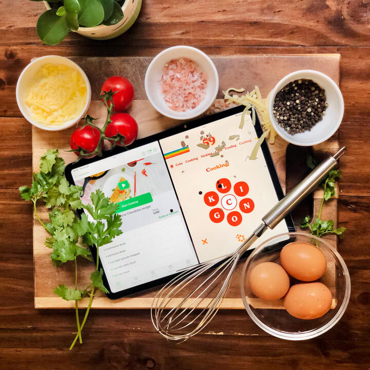 iPad on chopping board surrounded by food displaying the Retrogram game